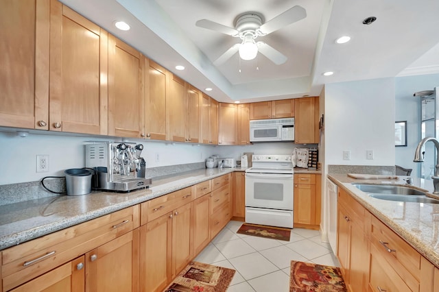 kitchen featuring white appliances, sink, ceiling fan, light tile patterned floors, and light stone counters