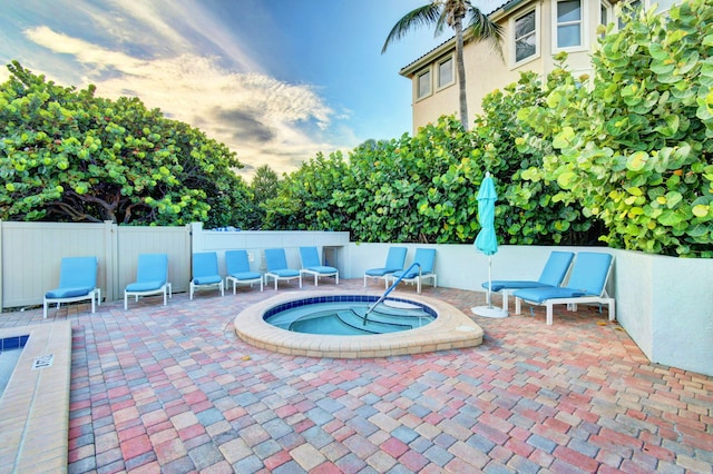 view of swimming pool with a hot tub