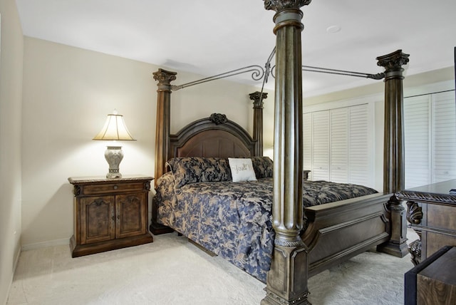 bedroom featuring a closet and light colored carpet