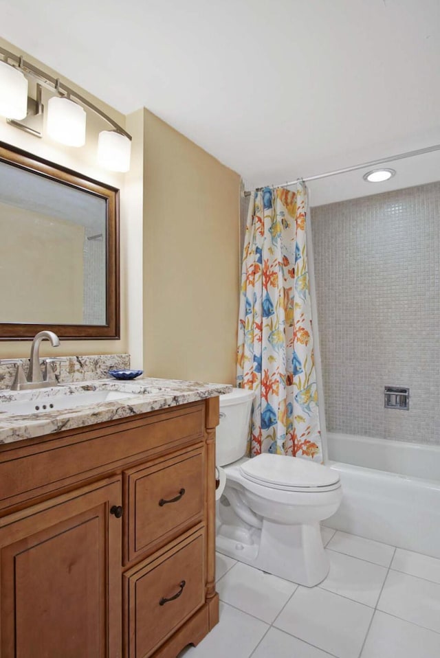 full bathroom featuring tile patterned flooring, shower / bath combination with curtain, vanity, and toilet