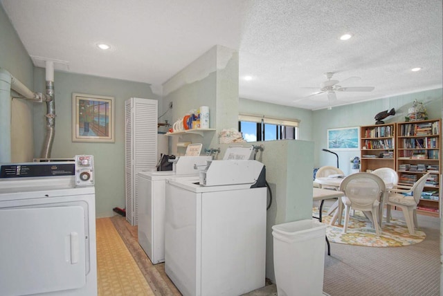 laundry room featuring washer and dryer, ceiling fan, and a textured ceiling