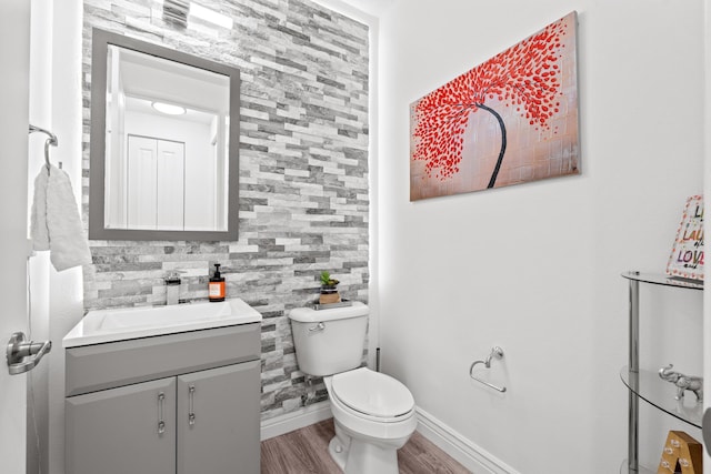 bathroom featuring hardwood / wood-style floors, vanity, and toilet