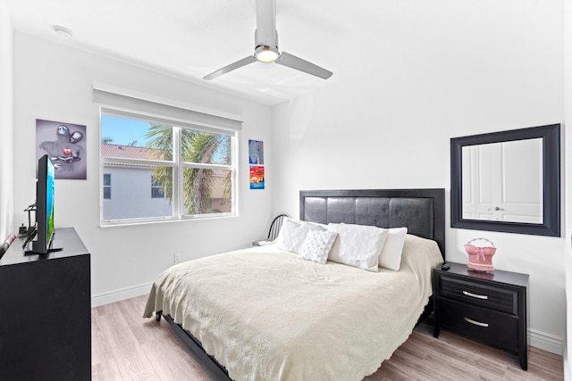 bedroom with ceiling fan and light hardwood / wood-style flooring