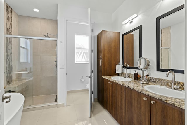 full bathroom with tile patterned floors, vanity, plus walk in shower, and toilet