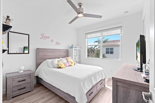 bedroom with ceiling fan and light hardwood / wood-style floors