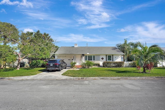 single story home featuring a garage and a front yard