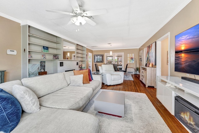 living room with dark hardwood / wood-style flooring, ceiling fan, and ornamental molding