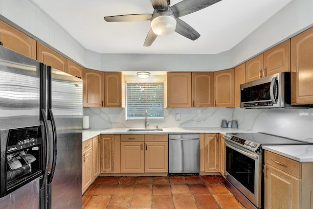 kitchen with backsplash, ceiling fan, sink, and appliances with stainless steel finishes