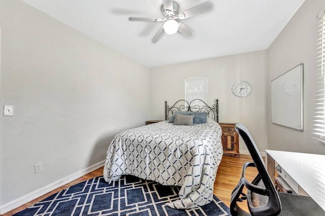 bedroom featuring ceiling fan and hardwood / wood-style flooring