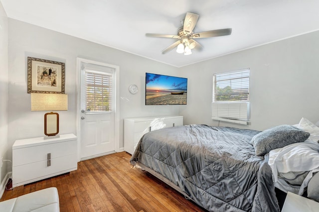 bedroom with ceiling fan, light hardwood / wood-style flooring, and multiple windows