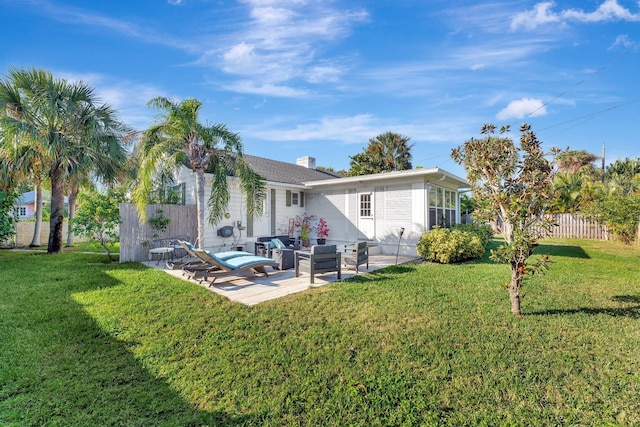 back of property with a lawn, a patio, and an outdoor hangout area