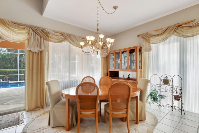 dining room with a notable chandelier and light tile patterned flooring