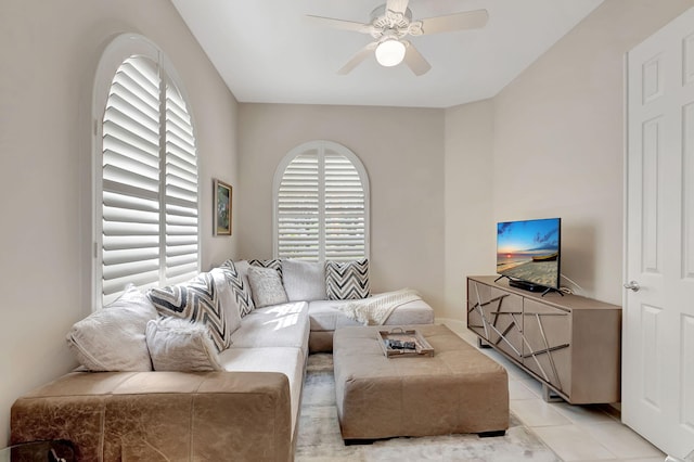 tiled living room featuring ceiling fan and a healthy amount of sunlight