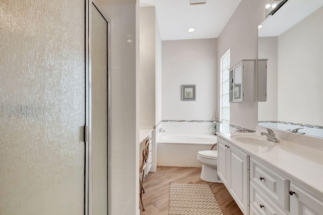 full bathroom with vanity, toilet, wood-type flooring, and plus walk in shower