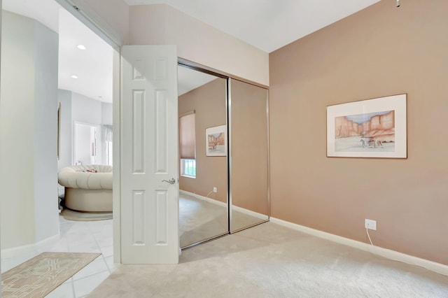 bedroom with light carpet and a closet