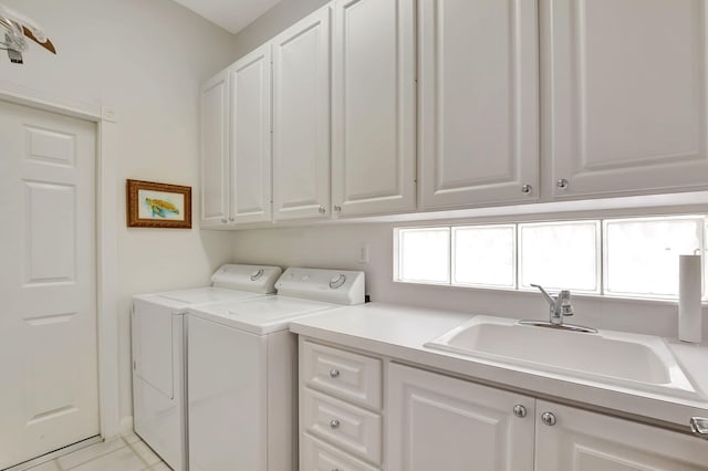 clothes washing area with separate washer and dryer, sink, light tile patterned floors, and cabinets