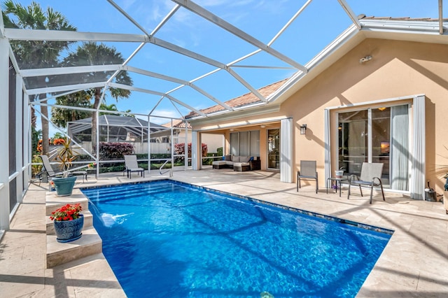 view of pool featuring glass enclosure, a patio area, outdoor lounge area, and pool water feature