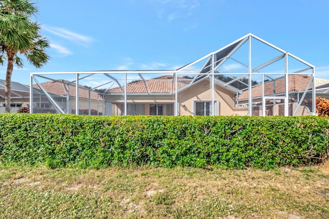 back of house featuring glass enclosure