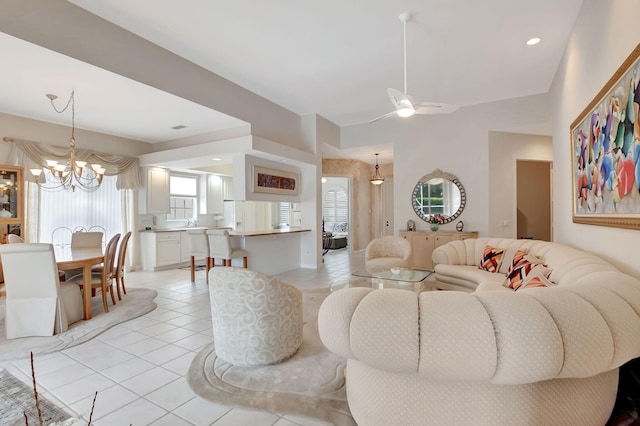 living room with light tile patterned floors and ceiling fan with notable chandelier