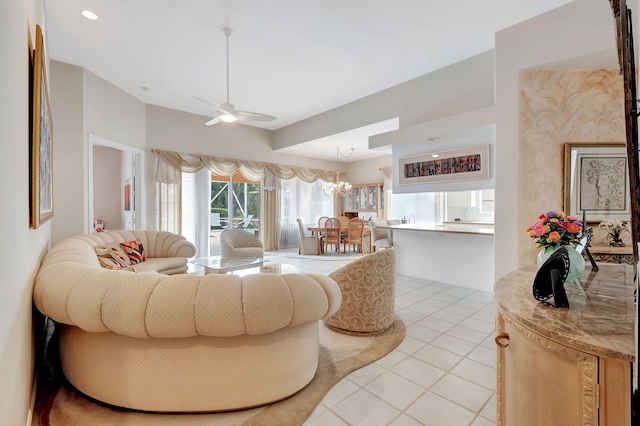 living room featuring ceiling fan with notable chandelier and light tile patterned flooring