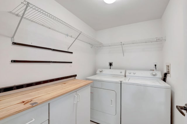 laundry area with cabinets and independent washer and dryer