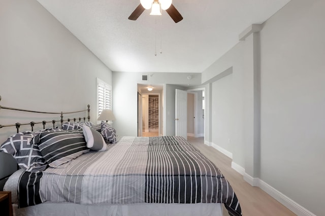 bedroom with light hardwood / wood-style flooring and ceiling fan