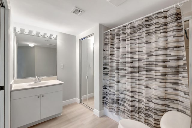 bathroom featuring a shower with curtain, vanity, toilet, and wood-type flooring