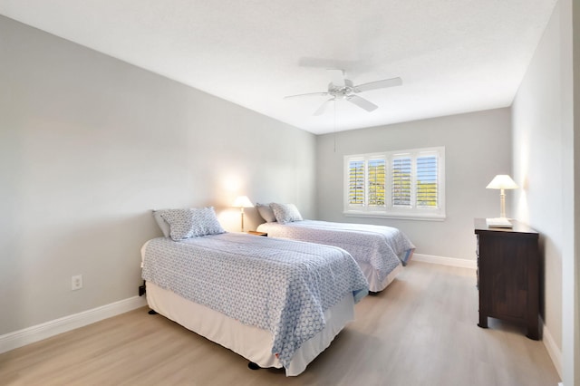 bedroom with ceiling fan and light wood-type flooring