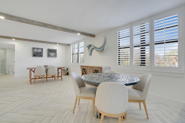 dining room with light parquet flooring and beam ceiling