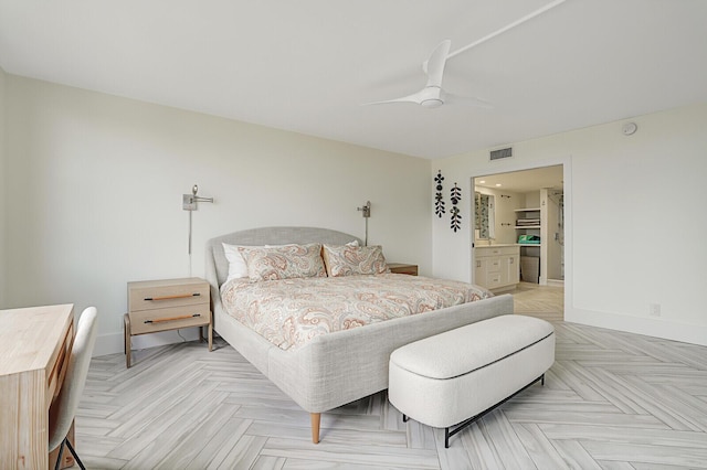 bedroom with ceiling fan, ensuite bathroom, and light parquet floors