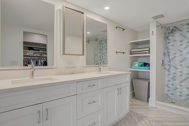 bathroom featuring a shower and vanity