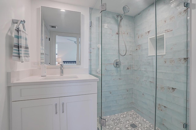 bathroom featuring vanity and a shower with shower door