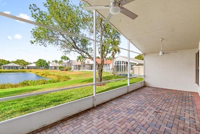 unfurnished sunroom featuring a water view, vaulted ceiling, and ceiling fan