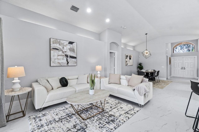 living room featuring lofted ceiling