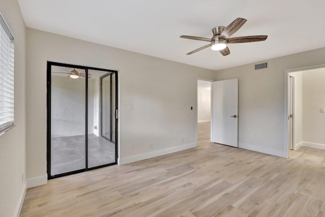 unfurnished bedroom featuring ceiling fan, a closet, and light hardwood / wood-style flooring