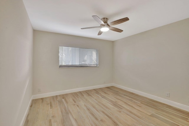 spare room with ceiling fan and light wood-type flooring