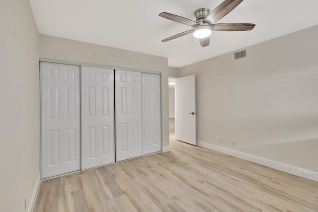 unfurnished bedroom with ceiling fan, a closet, and light hardwood / wood-style floors