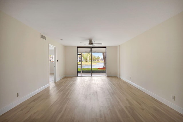 unfurnished room with ceiling fan and light wood-type flooring