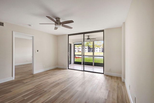 spare room featuring ceiling fan and light hardwood / wood-style floors