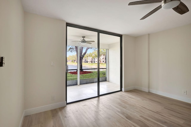 unfurnished room with ceiling fan and light hardwood / wood-style floors