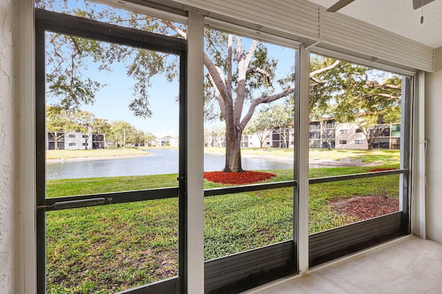 unfurnished sunroom featuring a water view