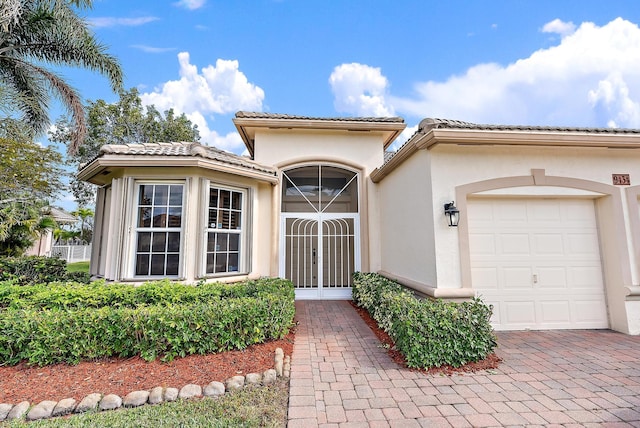 entrance to property with french doors and a garage