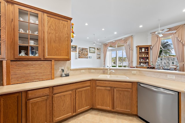 kitchen featuring tasteful backsplash, stainless steel dishwasher, ceiling fan, sink, and light tile patterned flooring