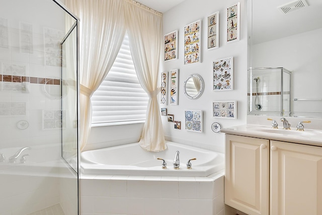 bathroom featuring vanity and separate shower and tub