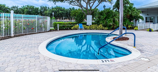 view of pool with a patio and ceiling fan