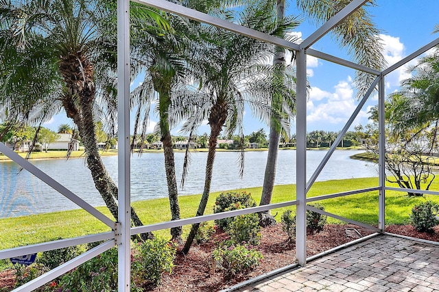 unfurnished sunroom featuring a water view