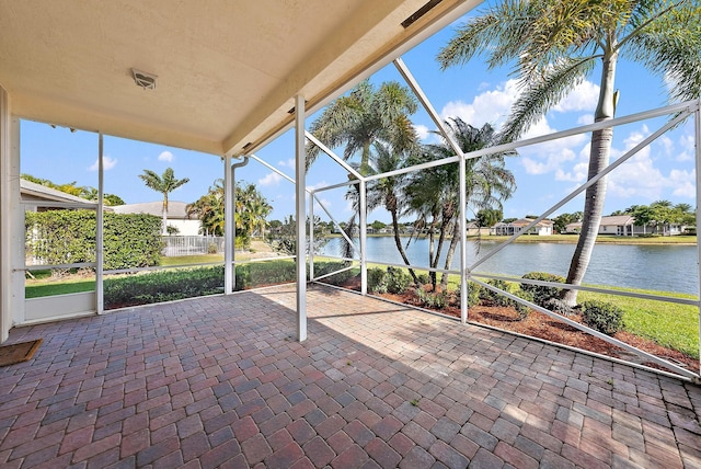 unfurnished sunroom with a water view