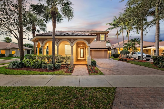 mediterranean / spanish-style home with a garage