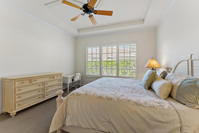 carpeted bedroom featuring crown molding, ceiling fan, and a tray ceiling