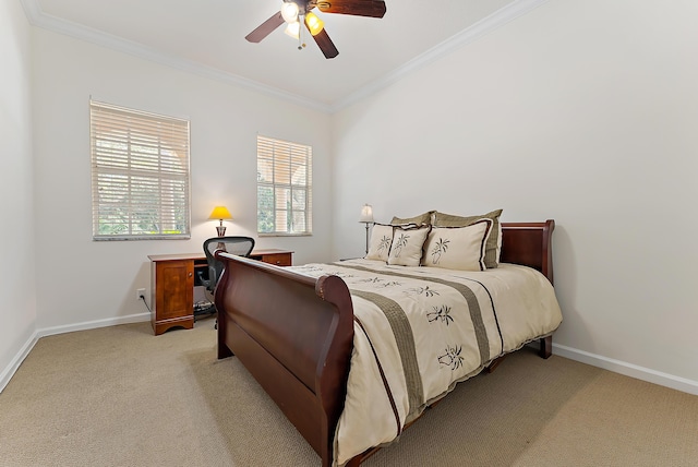 carpeted bedroom with ceiling fan and ornamental molding